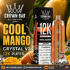 Al Fakher Crown Bar Big Cloud Crystal V2 Cool Mango disposable vape device and its black packaging box, set against a dynamic background of fresh mangoes and water splashes. The image features promotional text overlays and store contact details.