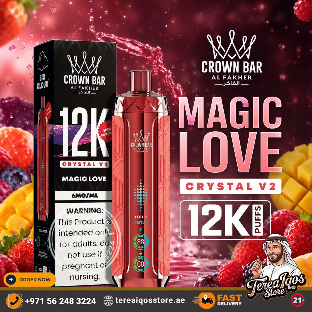 A promotional graphic for the Crown Bar Al Fakher Magic Love Crystal V2 vape device and its packaging. The device is a metallic pink-red color with a patterned design and a clear mouthpiece, shown alongside its black and white box.